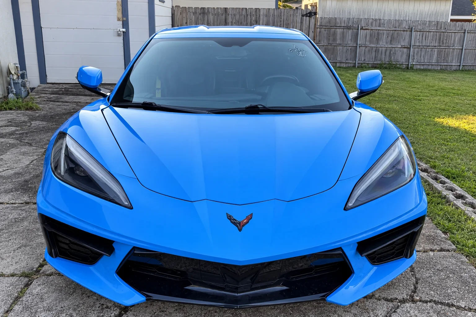 Front view of a blue Chevrolet Corvette with installed windshield.